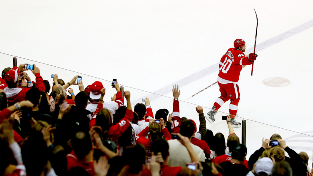 DETROIT, MI - FEBRUARY 14: Henrik Zetterberg #40 of the Detroit Red Wings salutes fans as the first star of the game after the Red Wings NHL record breaking 21st consecutive home victory defeating the Dallas Stars 3-1 at Joe Louis Arena on February 14, 2012 in Detroit, Michigan. (Photo by Gregory Shamus/Getty Images)